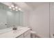 Bathroom with white tile and vanity with mirror at 15217 W 69Th Ave, Arvada, CO 80007