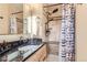 Bathroom with granite vanity, shower, and updated fixtures at 7041 S Quince St, Centennial, CO 80112