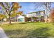 Brick ranch house with teal garage doors and landscaped yard at 6431 W Arbor Ave, Littleton, CO 80123