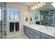 Bathroom with double vanity, large mirror, and shower at 13746 Legend Trl # 101, Broomfield, CO 80023