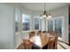 Bright dining area with wood table and chairs, and access to the backyard at 13746 Legend Trl # 101, Broomfield, CO 80023