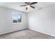 Well-lit bedroom featuring carpet and neutral wall colors at 206 Cedar St, Hudson, CO 80642