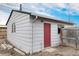 Detached shed with a red door in the backyard at 206 Cedar St, Hudson, CO 80642