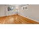 Living room with hardwood floors and large windows at 6681 Bellaire St, Commerce City, CO 80022