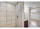 Bathroom with shower stall, tiled walls, and vanity at 6681 Bellaire St, Commerce City, CO 80022