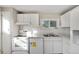 Modern white kitchen with new appliances and subway tile at 6681 Bellaire St, Commerce City, CO 80022