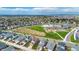 Aerial view of a house nestled in a quiet residential neighborhood near a school at 18000 E 100Th Ave, Commerce City, CO 80022