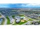 Aerial view of a residential area with a school and surrounding homes at 18000 E 100Th Ave, Commerce City, CO 80022