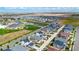 Aerial view showcasing a house and surrounding neighborhood with a school nearby at 18000 E 100Th Ave, Commerce City, CO 80022