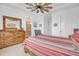 Main bedroom with dresser, chair and ensuite bathroom access at 18000 E 100Th Ave, Commerce City, CO 80022