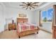 Bright bedroom featuring a wood bed frame and large window at 18000 E 100Th Ave, Commerce City, CO 80022