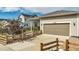 Two-car garage with driveway and a fenced yard at 18000 E 100Th Ave, Commerce City, CO 80022