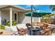 Cozy patio with fire pit, seating, and a green umbrella at 18000 E 100Th Ave, Commerce City, CO 80022