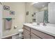 Clean bathroom with a single sink vanity and shower/tub combo at 18000 E 100Th Ave, Commerce City, CO 80022