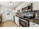 Modern kitchen with stainless steel appliances and a stylish backsplash at 3551 Leyden St, Denver, CO 80207