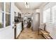 Modern kitchen with white cabinets, stainless steel appliances and a view into dining area at 3551 Leyden St, Denver, CO 80207