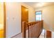 Upstairs hallway with carpeted flooring and wooden railing at 12133 Bannock Cir # D, Denver, CO 80234