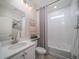 Clean and modern bathroom with a bathtub, white vanity, and tiled walls at 5176 N Quemoy Ct, Aurora, CO 80019