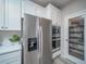 Kitchen with stainless steel appliances, white cabinets, and a walk-in pantry at 5176 N Quemoy Ct, Aurora, CO 80019