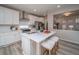 Modern kitchen featuring white cabinets, stainless steel appliances, and an island with seating at 5176 N Quemoy Ct, Aurora, CO 80019