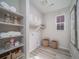 Well-organized laundry room with built-in shelving, washer/dryer hookups, and wicker baskets at 5176 N Quemoy Ct, Aurora, CO 80019