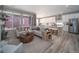 Open concept living room and kitchen area with modern furniture and large windows at 5176 N Quemoy Ct, Aurora, CO 80019