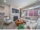 Inviting living room with fireplace, comfortable seating, and natural light at 5176 N Quemoy Ct, Aurora, CO 80019
