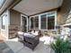 Relaxing covered patio with comfortable seating and views of the home's exterior at 5176 N Quemoy Ct, Aurora, CO 80019