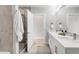 Modern bathroom with double vanity, large shower, and elegant tile at 2874 W Parkside Pl, Denver, CO 80221