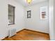 Simple bedroom with hardwood floors and multiple windows at 1111 N Corona St, Denver, CO 80218