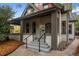 Front porch view of a charming home with gray paint, red roof, and steps at 1111 N Corona St, Denver, CO 80218