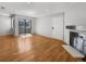 Living room with hardwood floors and sliding glass door to balcony at 1830 Newland Ct # 323, Lakewood, CO 80214