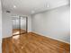 Bedroom with hardwood floors and mirrored closet doors at 1830 Newland Ct # 323, Lakewood, CO 80214