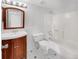 Bathroom with tub, toilet, and vanity with wood cabinet at 1830 Newland Ct # 323, Lakewood, CO 80214