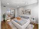 Virtually staged bedroom with hardwood floors and mirrored closet doors at 1830 Newland Ct # 323, Lakewood, CO 80214