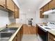 Kitchen features wood cabinets and a gas range at 1830 Newland Ct # 323, Lakewood, CO 80214