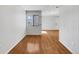Hardwood floor bedroom with large window and door to hallway at 1830 Newland Ct # 323, Lakewood, CO 80214