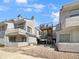 Condo building with multiple units, showing parking and building access at 1830 Newland Ct # 323, Lakewood, CO 80214