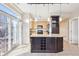 Modern kitchen with island, granite counters, and patio access at 9216 W 107Th Pl, Westminster, CO 80021