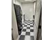 Kitchen with white cabinets, black appliances, and a checkerboard floor at 12172 Huron St # 207, Denver, CO 80234