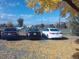 Three cars parked in a lot with autumn leaves at 12172 Huron St # 207, Denver, CO 80234