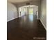 Open living room with dark hardwood floors and a view to the kitchen at 23671 E Alabama Dr, Aurora, CO 80018