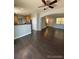 Open living room with dark hardwood floors and a view to the kitchen at 23671 E Alabama Dr, Aurora, CO 80018