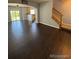 Open living room with dark hardwood floors and a view to the kitchen at 23671 E Alabama Dr, Aurora, CO 80018