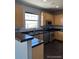 Kitchen with wood cabinets, stainless steel appliances and dark hardwood floors at 23671 E Alabama Dr, Aurora, CO 80018