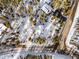 Aerial view of house with snowy landscape and wooded neighborhood at 878 American Way, Breckenridge, CO 80424