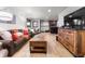 Finished basement recreation room with comfortable seating, a wet bar, and plenty of natural light at 878 American Way, Breckenridge, CO 80424