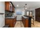 Basement wet bar with wood cabinets, copper sink, wine rack, and tile backsplash at 878 American Way, Breckenridge, CO 80424
