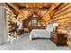 Main bedroom with log cabin walls and access to balcony at 878 American Way, Breckenridge, CO 80424