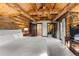 Main bedroom with log cabin walls and ensuite bathroom at 878 American Way, Breckenridge, CO 80424